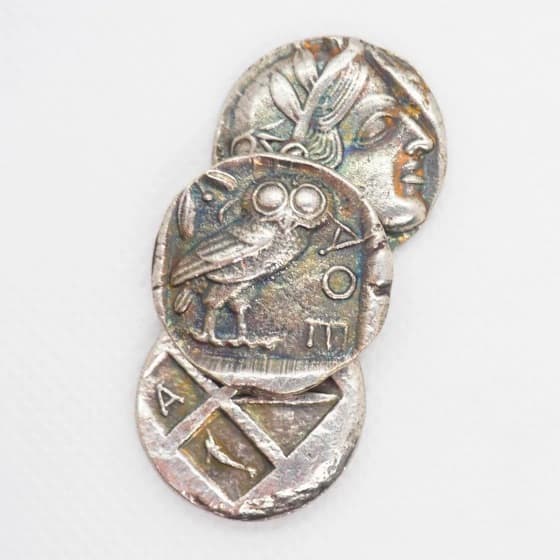 Ancient Athenian coins with the owl of Athena — wisdom and discovery